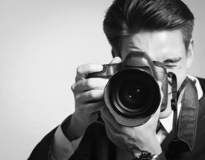 Young man using a professional camera